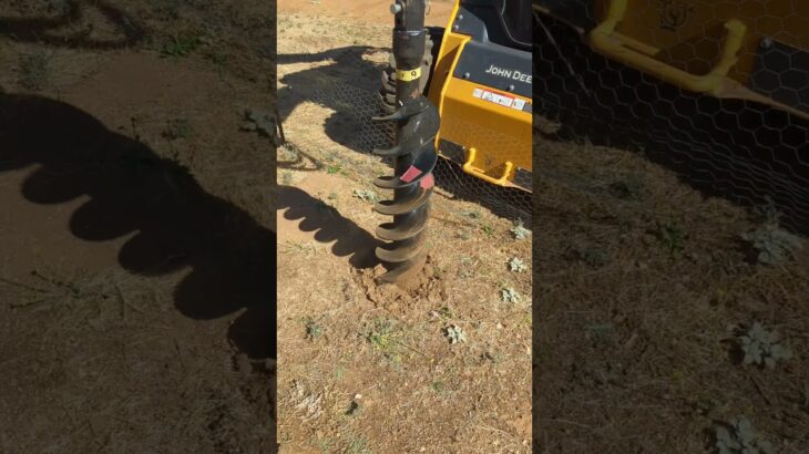 drilling another pole hole with John Deere tractor