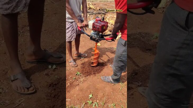 Earth auger working with large bit drilling holes on earth with machine @farmer_Arjun_creations